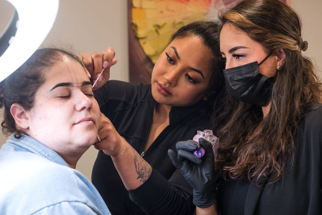 Instructor demonstrating Nano Brow technique during advanced PMU training near Boston