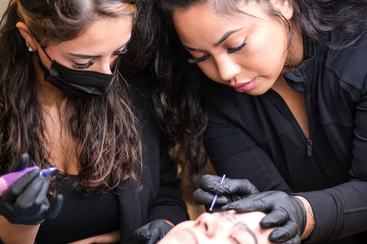 Microblading course student practicing on a live model in Massachusetts